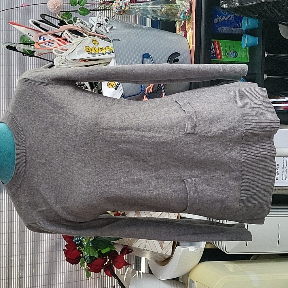 Ladies long sleeve sweater front pockets,  side slits.